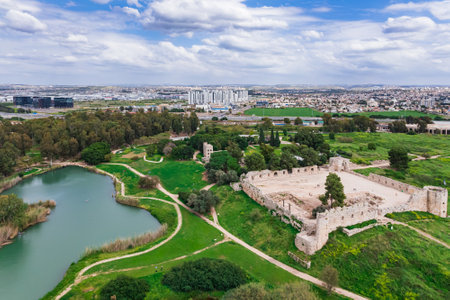The picturesque lake brings wonderful coolness. Ruins of the ancient city of Antipatris. Drone footage. Spring in Israel. Fresh green grass grows on the hills of Yarkon Park.の写真素材