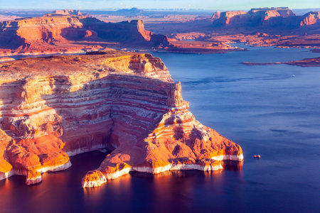 USA. States of Utah and Arizona. Huge lake of among the red sandstone cliffs. Small islands stick out of the water. Photo from a bird's eye view. Lake Powell is a reservoir on the Colorado River.の写真素材