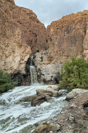 Unexpected powerful waterfalll. Israel, winter cloudy day. The Judean Desert around the Dead Sea after heavy winter rains.の写真素材