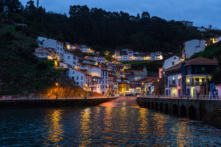 Picturesque reflection in sea water. Evening twilight in Cudillero. Magical Asturias. Spain. The village is an amphitheater around the ocean bay.の写真素材