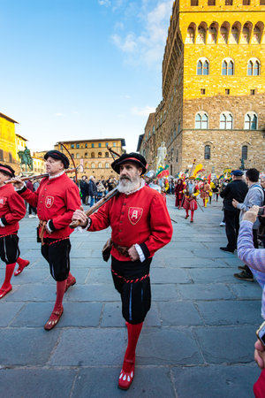 FLORENCE, ITALY - NOVEMBER 30, 2019: Fancy-dress procession on the Signoria Square. Medieval guards with crossbows. The most famous building in the world - Palazzo Vecchioのeditorial素材