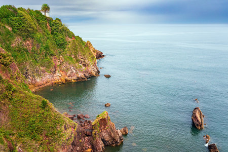 Steep rocky ocean shore. Candas. Part of the famous Costa Verde beach. Atlantic coast, Spain. Mild autumn weather. Romantic trip to Spain.の写真素材
