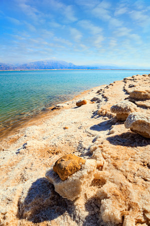 Evaporated salt forms Ñrystals on the surface of the water. The Dead Sea is an endorheic, very salty lake in the Middle East. The famous resort on the Dead Sea. Coast of Israel.の写真素材