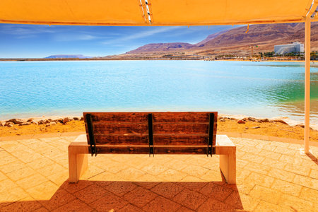 Romantic bench by the Dead Sea. Picturesque gallery on the seashore. Coast of Israel. The drainless salt lake in the Middle East.の写真素材