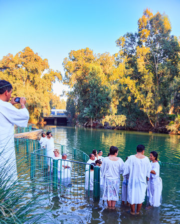 YARDENIT, ISRAEL - JANUARY 21, 2012: Rite of baptism of believers. Believers enter the waters of the Jordan River. Yardenit is the exit point of the Jordan River from the Sea of Galilee.のeditorial素材