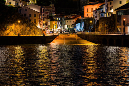Picturesque reflection in sea water. Evening twilight in Cudillero. The village is an amphitheater around the ocean bay. Magical Asturias. Spain.の写真素材