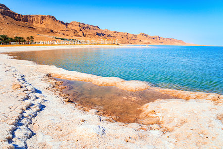 Coast of Israel. The famous resort on the Dead Sea. Evaporated salt forms Ñrystals on the surface of the water. The Dead Sea is an endorheic, very salty lake in the Middle East.の写真素材
