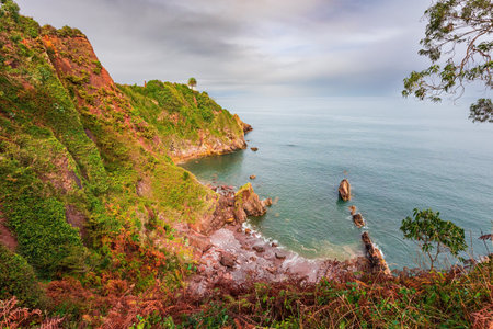 Steep rocky ocean shore. Part of the famous Costa Verde beach. Candas. Atlantic coast, Spain. Mild autumn weather. Romantic trip to Spain.の写真素材