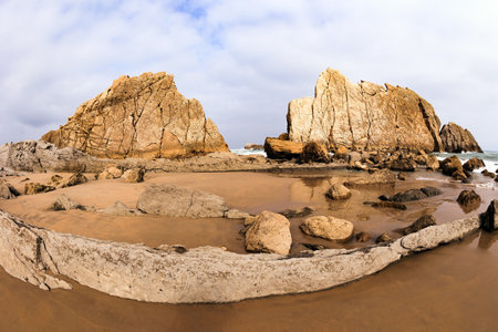 Cantabria, Spain. Incredible rock formations, stones and boulders. The Playa de la Arnia beach. Picturesque coastal cliffs. Amazing geological formations amaze tourists.の写真素材