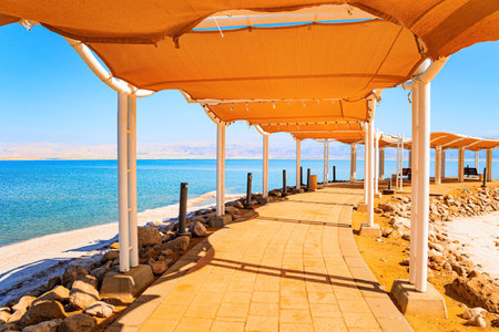 Long covered gallery on the beach. Famous resort in Israel. The Dead Sea is very salty lake in the Middle East. Evaporated salt forms Ñrystals on the water. Dead Sea Shore.の写真素材
