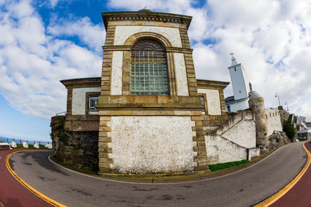 Beautiful road to lighthouse and Chapel de la Atalaya. Unusual impressive architecture of the Luarca. Romantic trip to Spain. Atlantic coast, Asturias.の写真素材