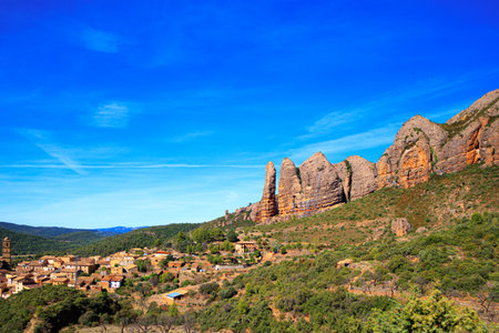 The magical nature of Spain. Aguero village at the foot of the dangerous and magnificent Mallos cliffs. Province of Huesca, Aragon. Romantic trip to northern Spain.の写真素材