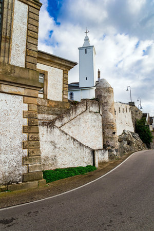 Beautiful road to lighthouse and Chapel de la Atalaya. Atlantic coast, Asturias. Unusual impressive architecture of the Luarca. Romantic trip to Spain.の写真素材