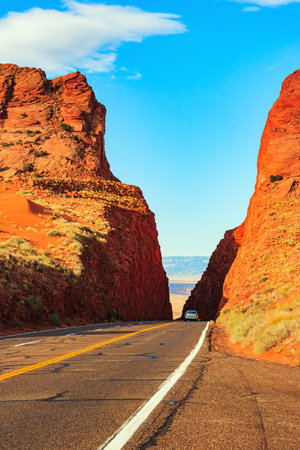 Scenic road carved between steep Navajo red sandstone cliffs. The historic Lees Ferry on the Colorado River. The Grand Canyon National Park.の写真素材