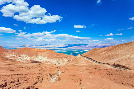 Judean desert on the shores of the Dead Sea. Dry waterless hills of yellow, beige and gray clay. Shooting from a drone. Israelの写真素材