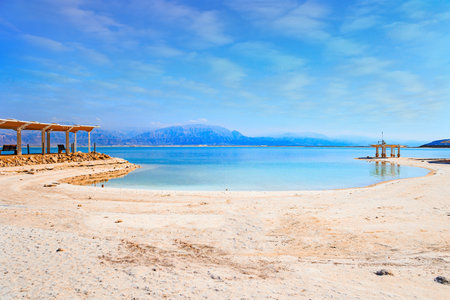 Coast of Israel. Evaporated salt forms Ñrystals on the surface of the water. The Dead Sea is an endorheic, very salty lake in the Middle East. The famous resort on the Dead Sea.の写真素材