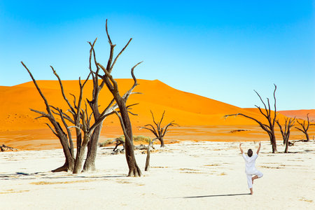 Woman doing yoga. Namib Desert. Deadvlei is the main natural attraction in the Park Namib-Naukluft.の写真素材