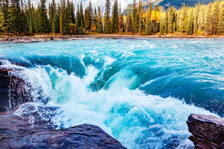 Athabasca Falls is the most powerful waterfall in Alberta. Canadian Rockies. The water of the Athabasca River are of glacial origin and turquoise in color. Jasper Park.の写真素材