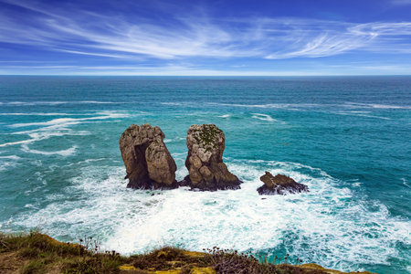 Cantabria. Windy stormy day on the Atlantic coast.  Noon on the beach of Playa di Arnia, Spain. Rocky picturesque ocean coast.の写真素材