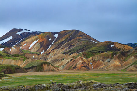 Landmannalaugar. Travel to exotic Iceland. Rhyolite mountains, solidified lava flows and streams changing their courses. Huge swamp overgrown with green grassの写真素材