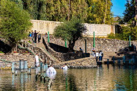 YARDENIT, ISRAEL - JANUARY 21, 2023: Joyful pilgrims receive baptism in the cold water of the Jordan River. Baptism center for Catholics and Orthodox Christians.のeditorial素材