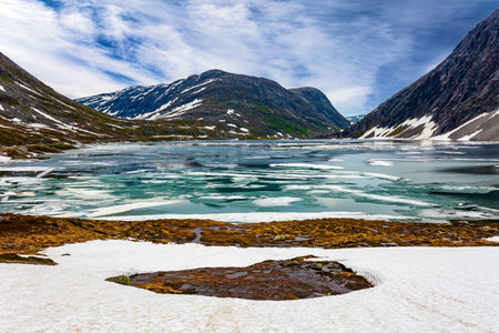 Possession of Santa Claus. Lake Djupvatnet is covered with ice in July. The very cold clear water of the lake is covered with ice. Summer trip to Norwayの写真素材