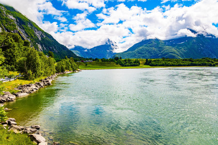 Wonderful fresh green forrst. Huge, lovely lake surrounded by picturesque round hills. Gorgeous sunny weather in Norway.の写真素材