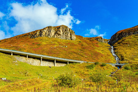 The famous mountain road Grossglognerstrasse. The picturesque serpentine of a beautiful asphalt highway winds along the steep mountain slopes. Sunny day in October.の写真素材