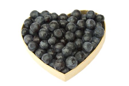 Bilberries (eruopean blueberries) in heart shaped box, isolated on white backgroundの写真素材