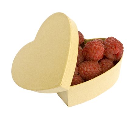 Raspberries in a heart shaped box, isolated on white background.の写真素材