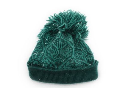 Warm woolen hat on white background covered with snowflakesの写真素材