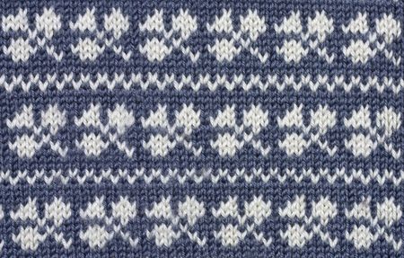 Knitted  white shamrock pattern on blue backgroundの写真素材