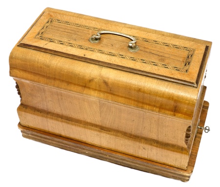 Old antique art deco wooden sewing machine box isolated on whiteの写真素材