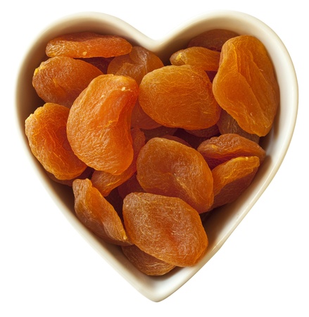 Heart filled with dried apricots, with clipping-pathの写真素材