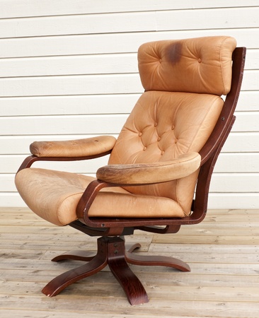 Old worn and dirty brown leather recliner chairの写真素材