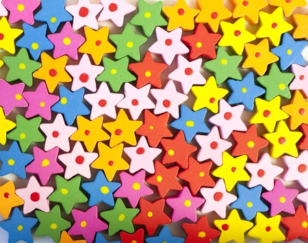 Background of many colorful painted wooden bead starsの写真素材