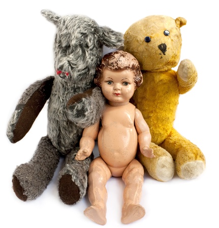Two teddy bears and a doll on white backgroundの写真素材