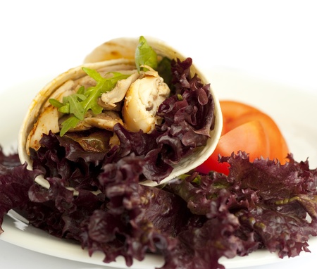 Delicious wrap filled with grilled chicken and colorful lettuceの写真素材