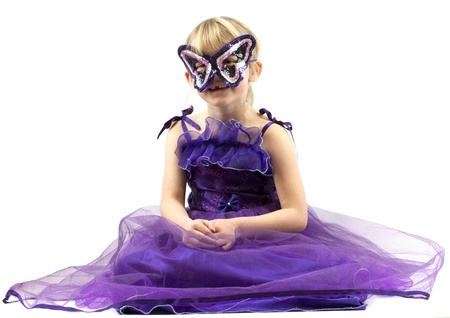 Little girl (6 years old) in purple dress and maskの写真素材