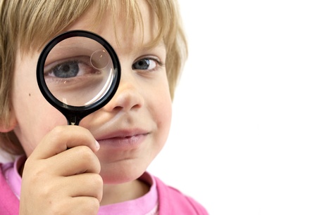 Girl with magnifying glass on white backgroundの写真素材