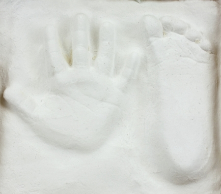 Little child's hand and foot print in gypsumの写真素材