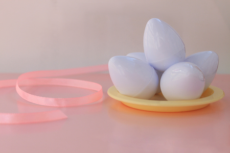 Plastic toys eggs on pink background close upの写真素材