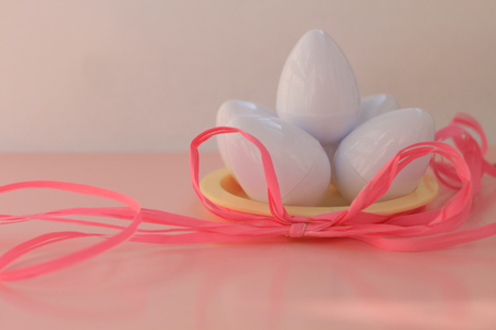 Plastic toys eggs on pink background close upの写真素材