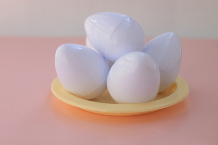 Plastic toys eggs on pink background close upの写真素材
