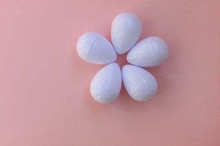 Plastic toys eggs on pink background close upの写真素材