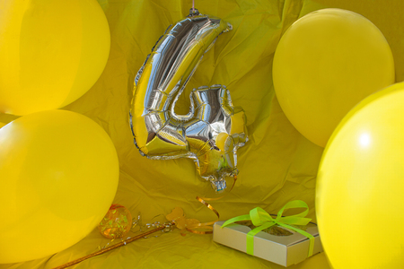 Celebration yellow background, a gift box with ribbon, magic ball and wand. Copy space.の写真素材
