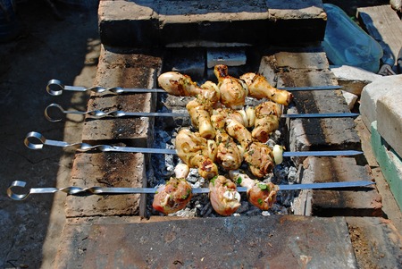 Roasted on fire chiken with herbs, spices and tomato sauce. A delicious and refined way of preparing chiken legs on grill.の写真素材