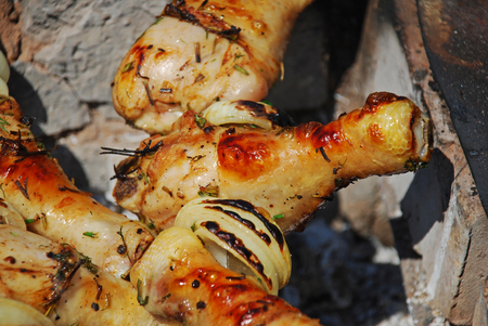 Roasted on fire chiken with herbs, spices and tomato sauce. A delicious and refined way of preparing chiken legs on grill.の写真素材