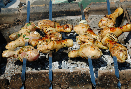 Roasted on fire chiken with herbs, spices and tomato sauce. A delicious and refined way of preparing chiken legs on grill.の写真素材