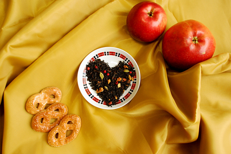Spicy black tea Cristmas cookies with buds of a clove, a coriander, slices of apples, oranges, pink pepper. Very tasty and aromatic, tones up and improves digestion.A great gift for your beloved.の写真素材